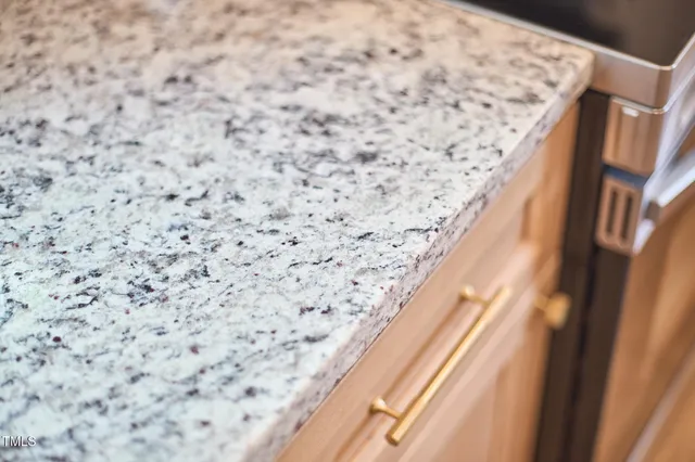 a kitchen with stainless steel appliances granite countertop a sink a stove and a microwave