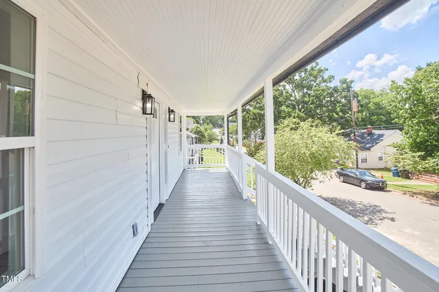 a view of a balcony with wooden floor