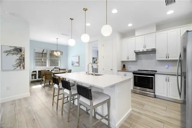 a kitchen with a stove a table and chairs in it