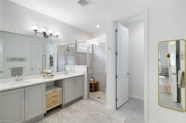 a bathroom with a double vanity sink mirror and double