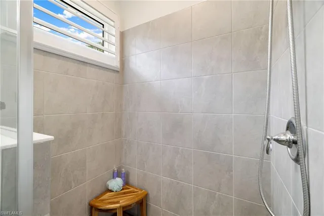 a bathroom with a window a toilet and a shower