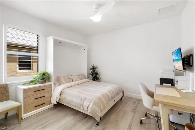 a bedroom with a bed and a desk