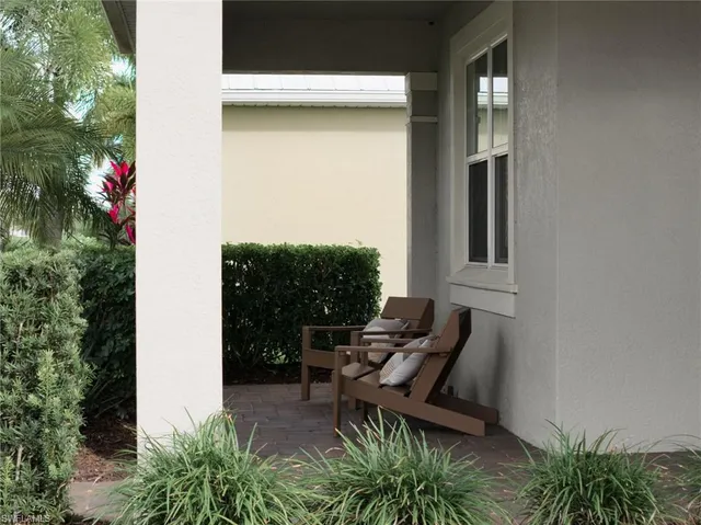 a view of backyard with outdoor seating and plants