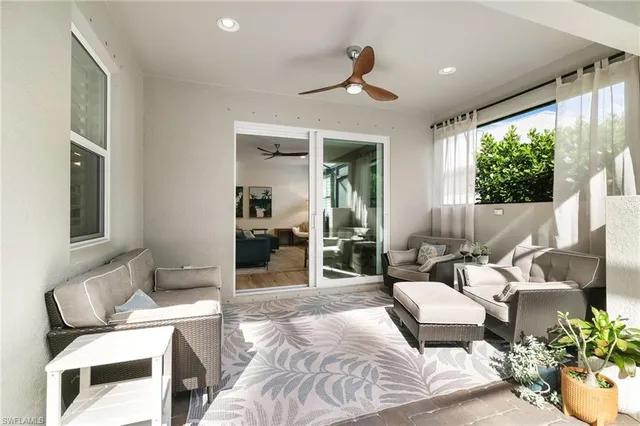 a bedroom with furniture and a large window