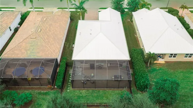 an aerial view of a house with a yard and balcony