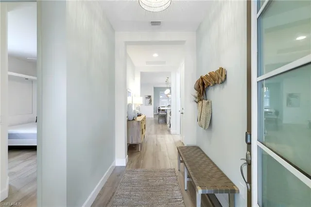 a walk in closet and view of bathroom