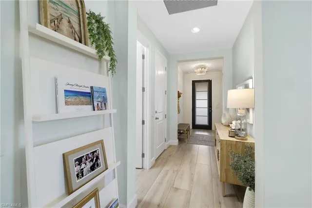 a view of a hallway view with wooden floor and staircase