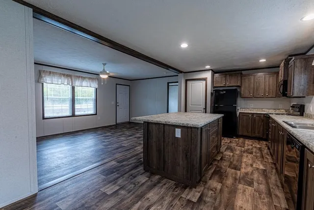 a kitchen with wooden floors and wooden cabinets