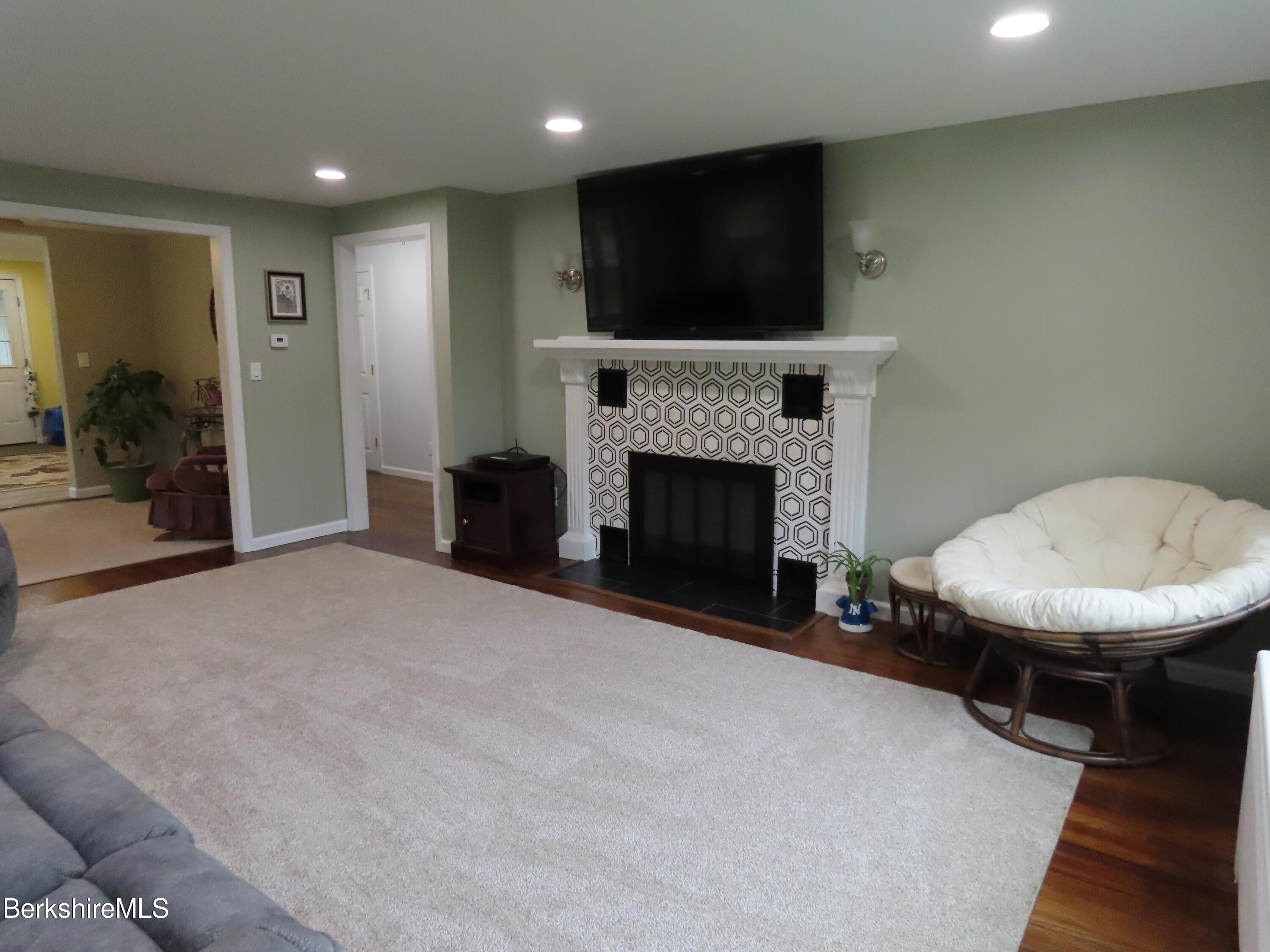 1580 Main Road Stamford, VT 05352 - Photo 14 of 39 a view of a livingroom with a fireplace and a couch