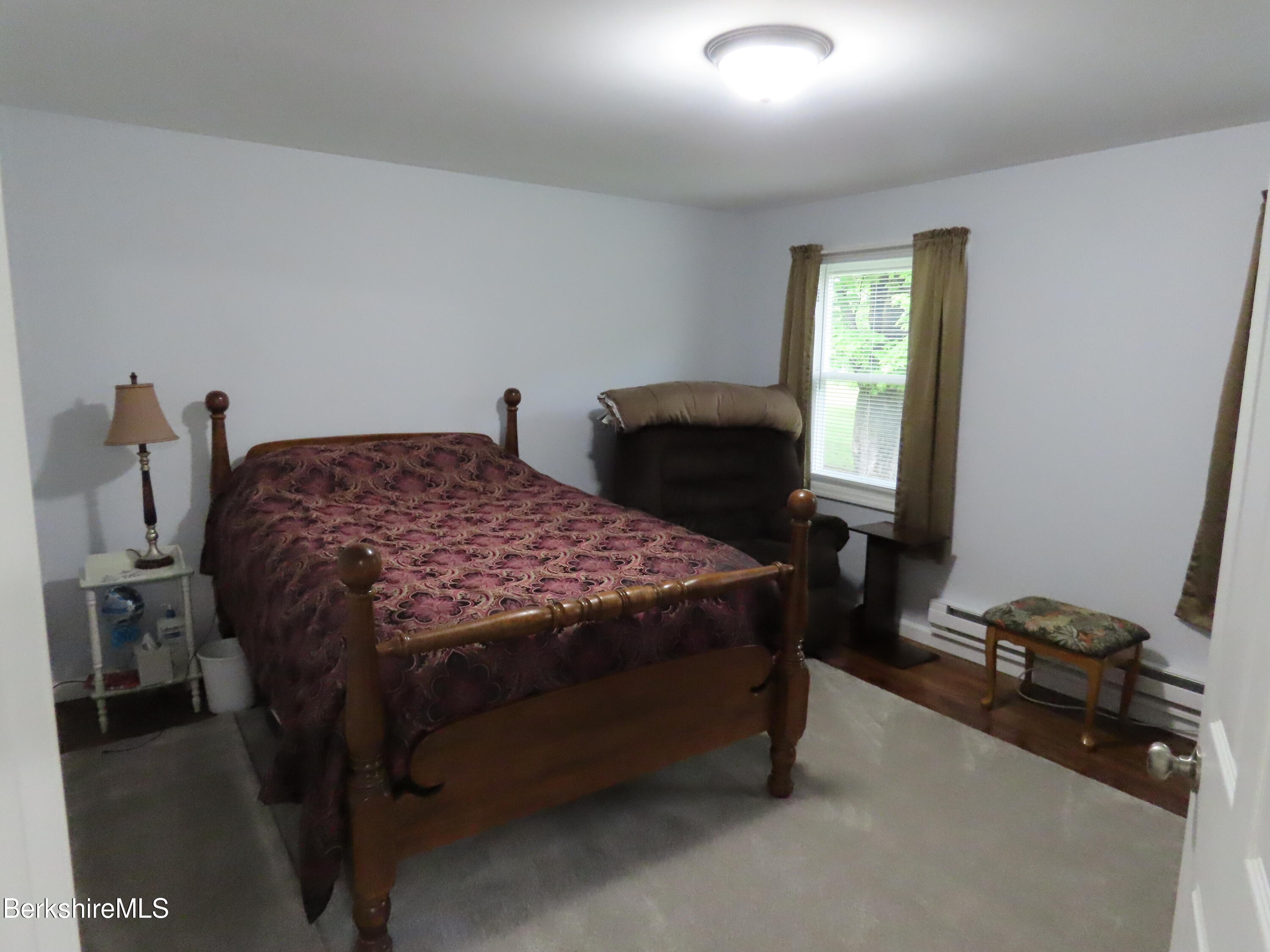 1580 Main Road Stamford, VT 05352 - Photo 20 of 39 a bedroom with a bed next to a window