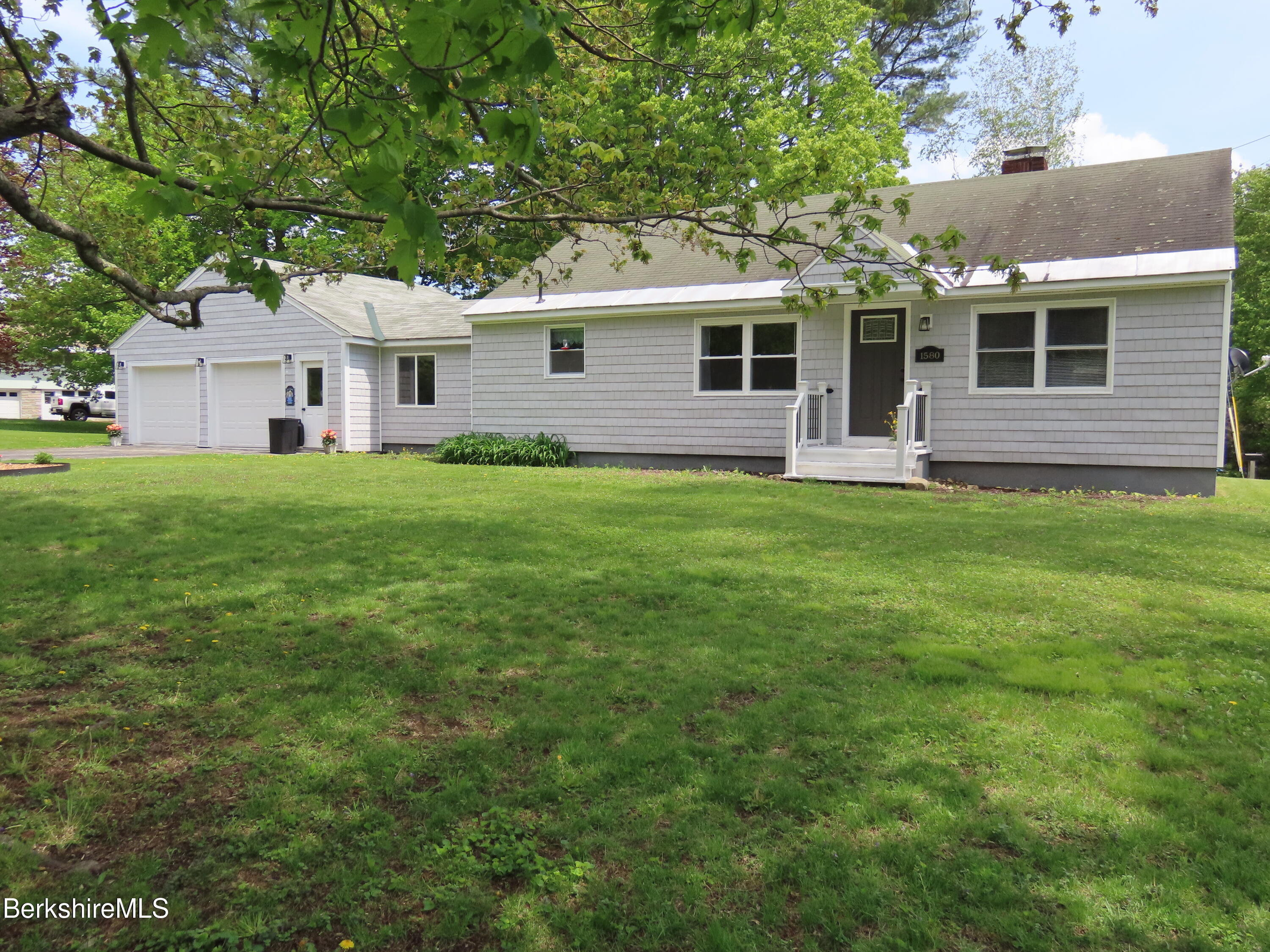 1580 Main Road Stamford, VT 05352 - Photo 2 of 39 a front view of a house with a garden