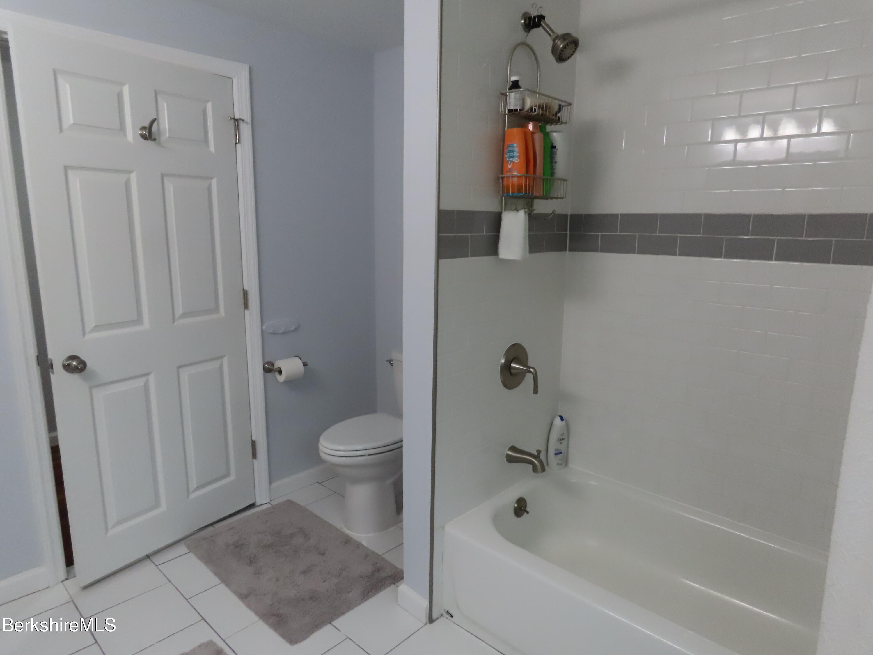 1580 Main Road Stamford, VT 05352 - Photo 23 of 39 a bathroom with a granite countertop sink a toilet and bathtub