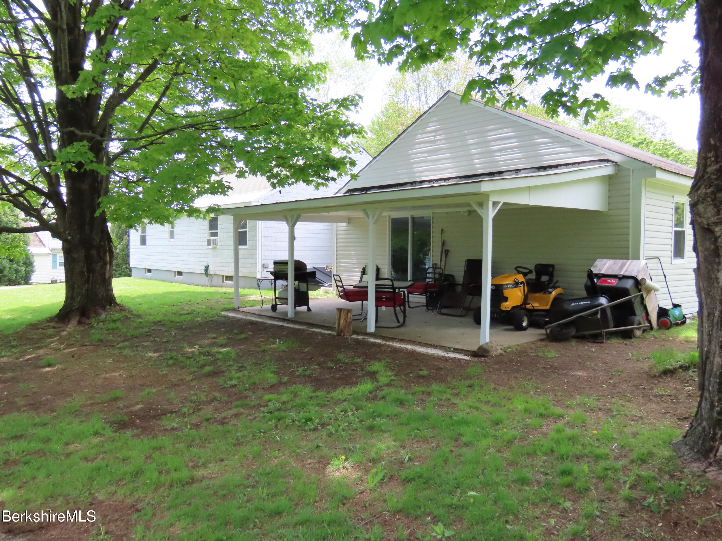 1580 Main Road Stamford, VT 05352 - Photo 35 of 39 a view of a backyard with table and chairs under an umbrella