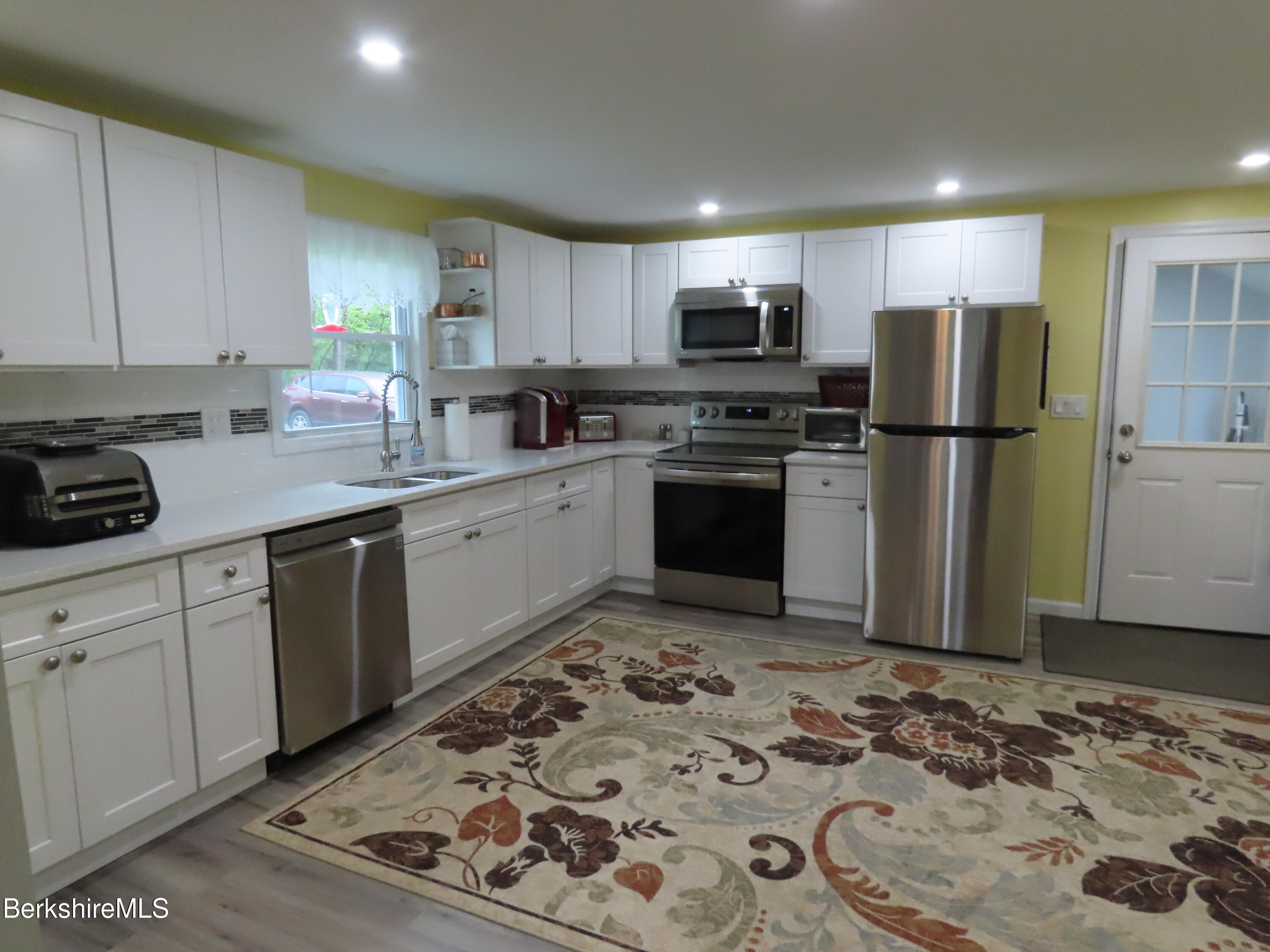 1580 Main Road Stamford, VT 05352 - Photo 5 of 39 a kitchen with stainless steel appliances granite countertop a refrigerator sink and stove
