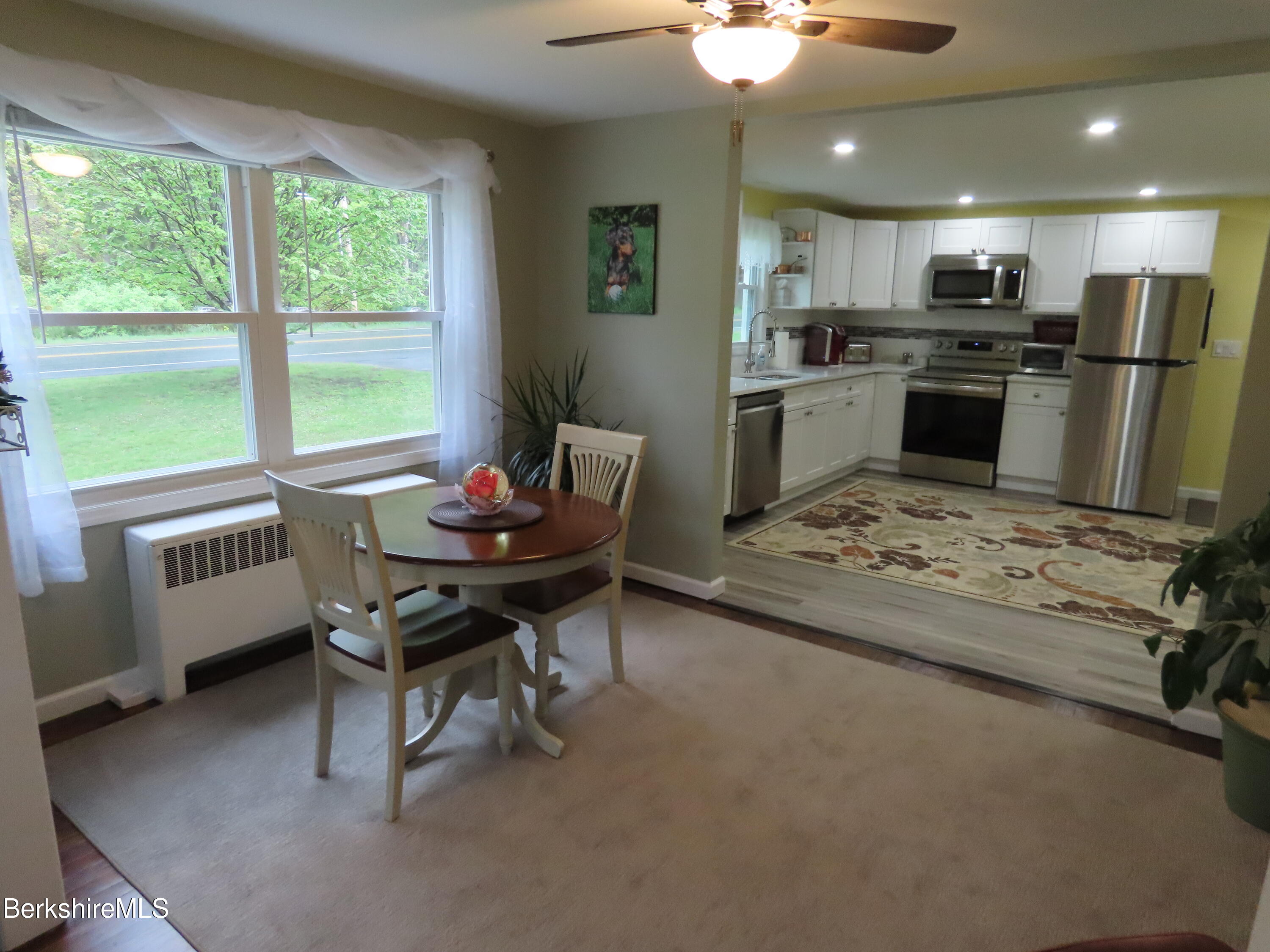 1580 Main Road Stamford, VT 05352 - Photo 8 of 39 a kitchen with kitchen island a dining table and chairs