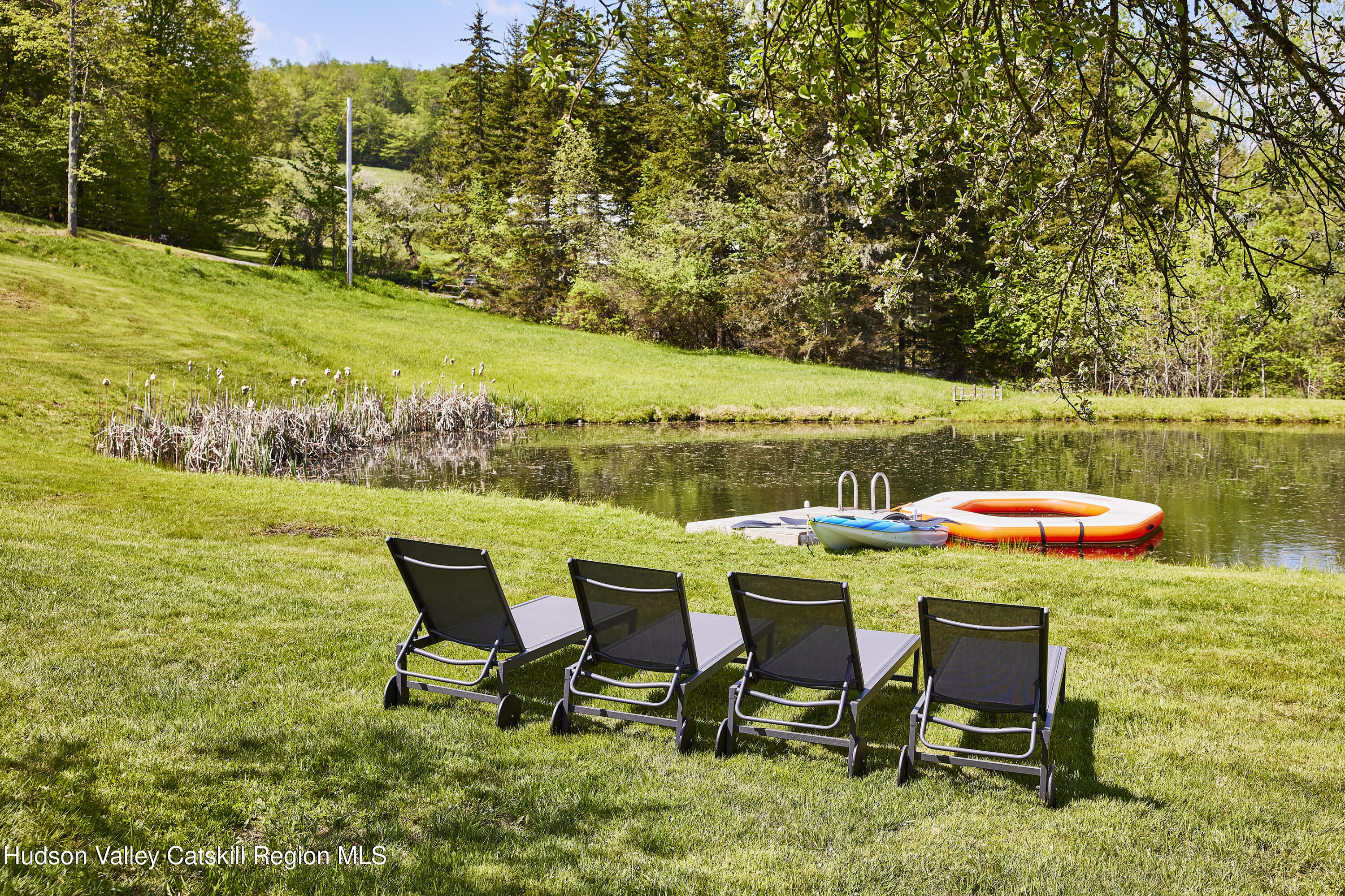 55 Hunter Road Parksville, NY 12768 - Photo 27 of 35 a view of a swimming pool with lawn chairs under an umbrella