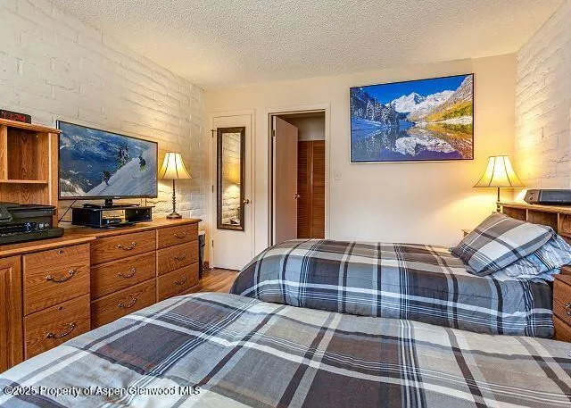 a bedroom with a bed and a view of balcony