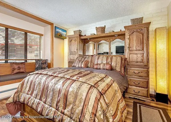 a bedroom with a bed and a large window