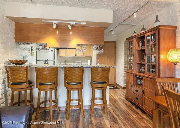 a dining room with furniture and wooden floor