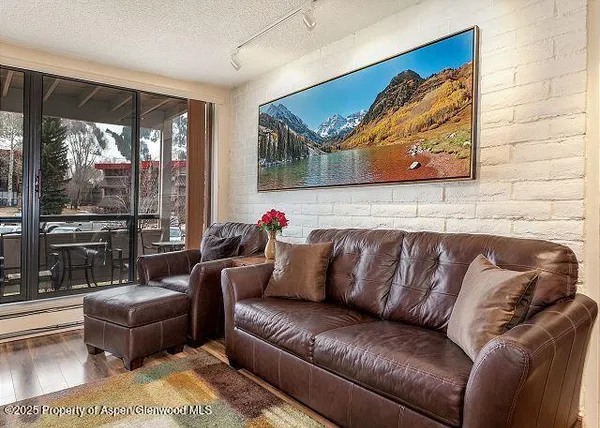 a living room with furniture and a floor to ceiling window