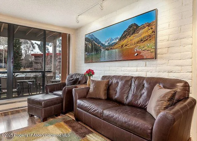 a living room with furniture and a floor to ceiling window