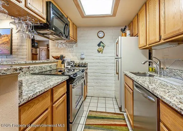 a kitchen with stainless steel appliances granite countertop a sink and cabinets
