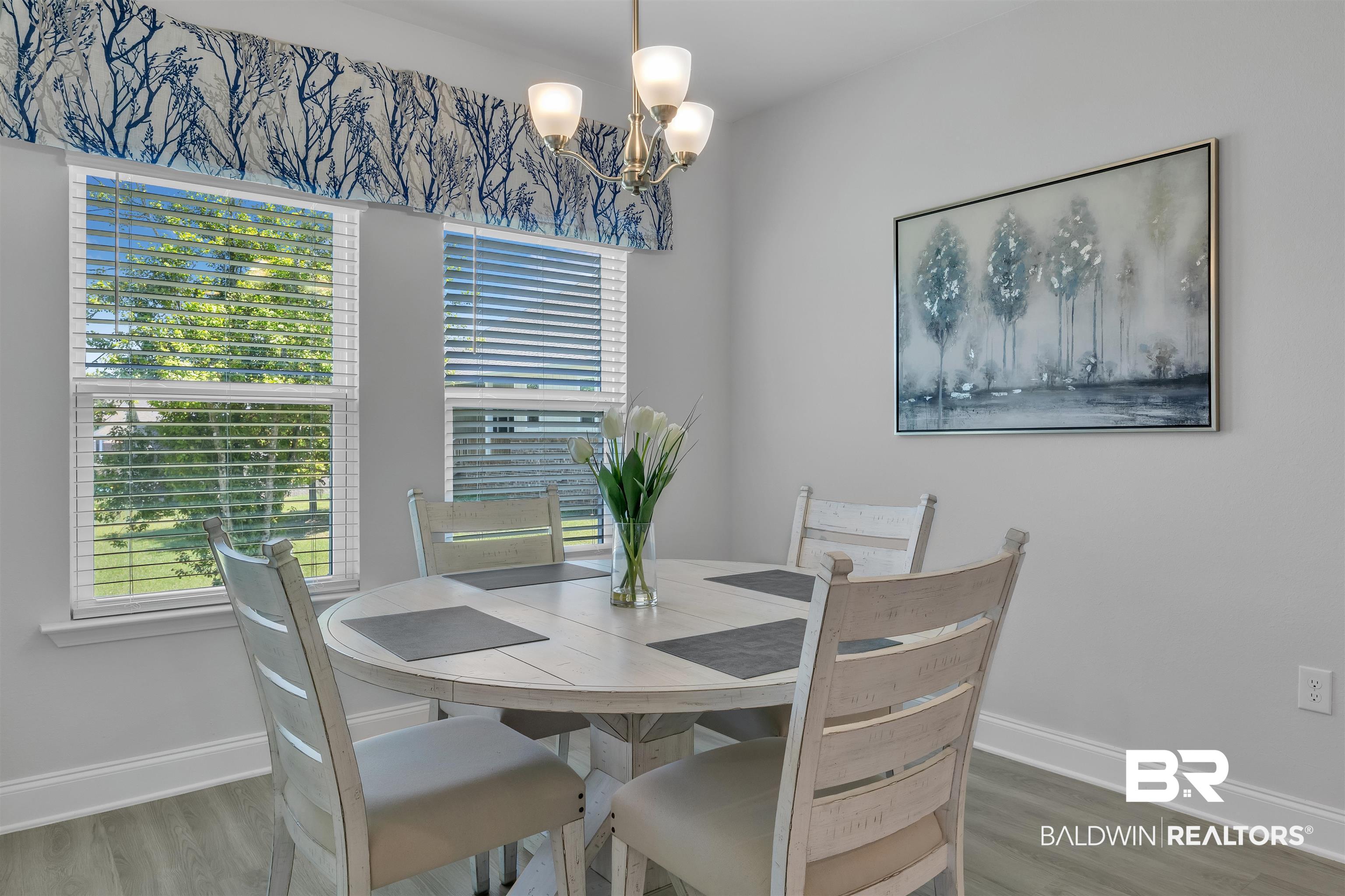 27862 Jade Court Daphne, AL 36526 - Photo 15 of 33 Dining area with baseboards, a chandelier, and wood finished floors