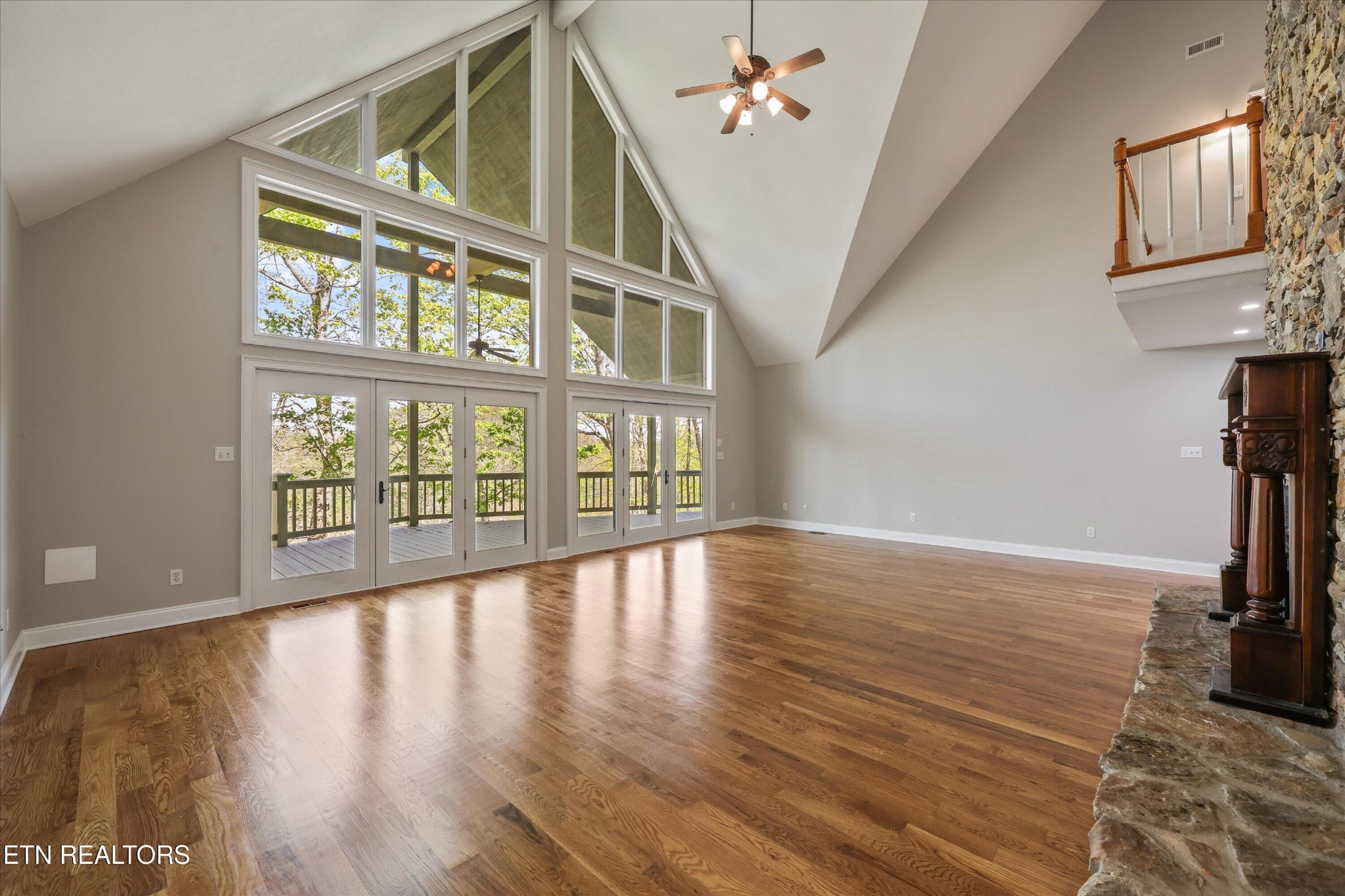 865 Stonegate Way Townsend, TN 37882 - Photo 7 of 60 a view of an empty room with wooden floor and a window