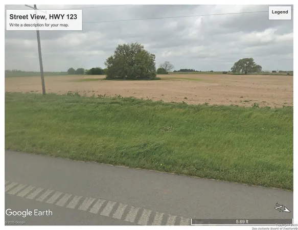a view of a field with an ocean view