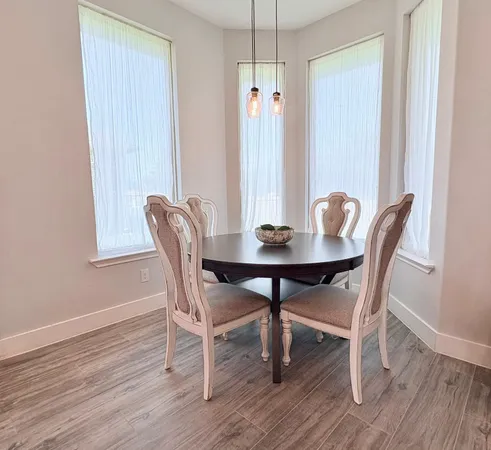 a view of a dining room with furniture window and wooden floor