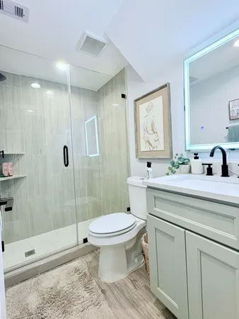 a bathroom with a sink toilet and shower