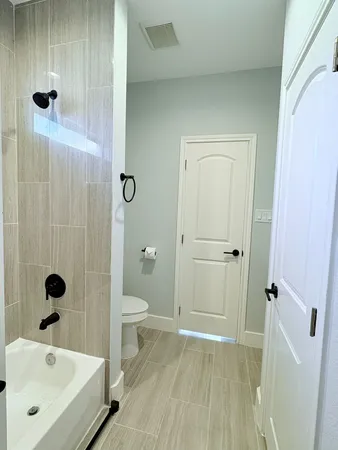 a bathroom with a tub and shower