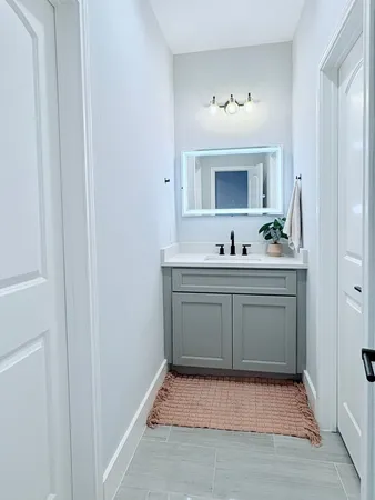 a bathroom with a sink and a mirror