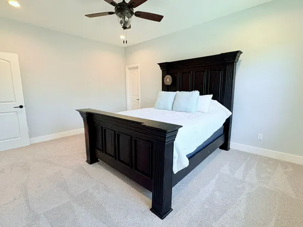 a bedroom with a bed and a chandelier