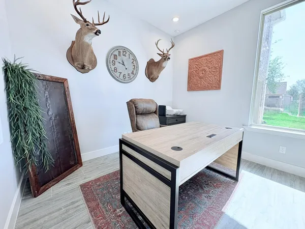 a view of a hallway with wooden floor and a bookshelf