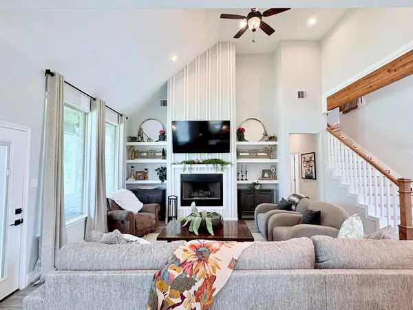 a living room with fireplace furniture and a fireplace