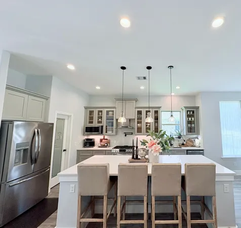 a kitchen with refrigerator and cabinets
