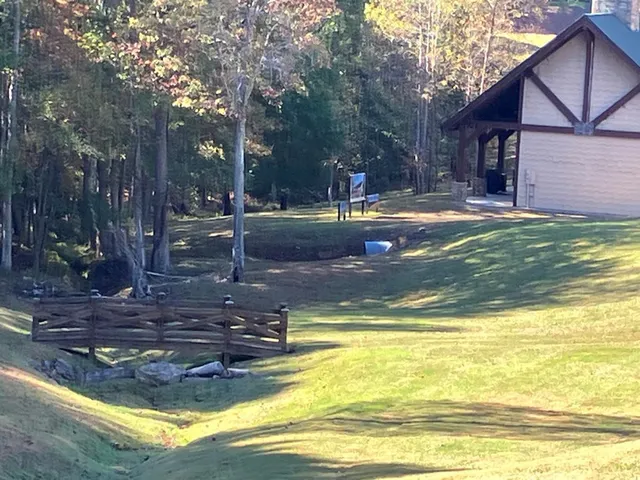 a view of a swimming pool with a house in the background