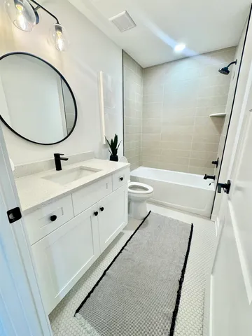 a bathroom with a sink a toilet and a mirror