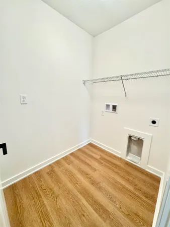 a view of a room with wooden floor and fan