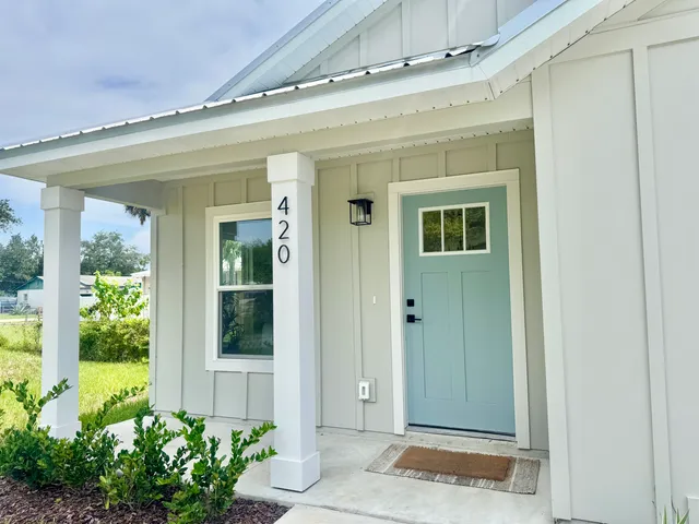 front view of a house with a potted plant