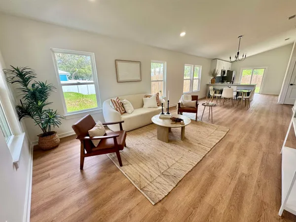 a living room with furniture or couch and a wooden floor