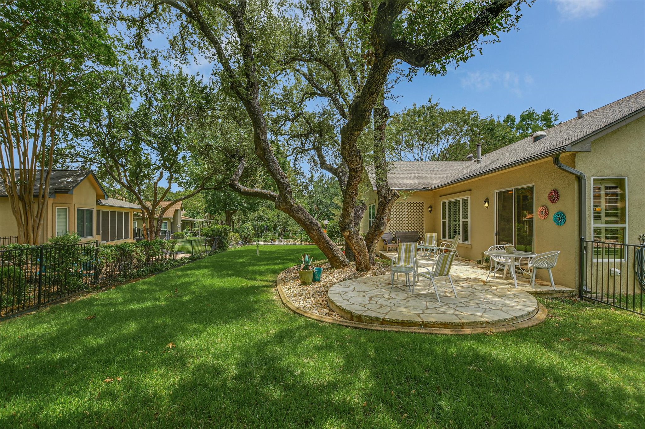 106 Nighthawk Way Georgetown, TX 78633 - Photo 25 of 29 A spacious backyard features a circular stone patio, perfect for outdoor dining and relaxation.