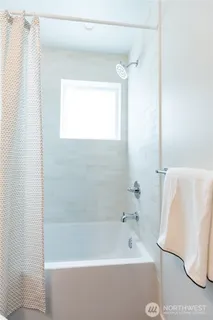 a bathroom with a bathtub and a shower