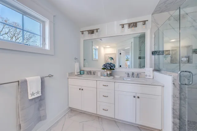 a bathroom with a double vanity sink and mirror