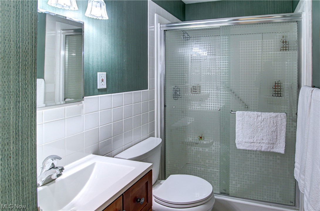 3711 Ruth Drive Brunswick, OH 44212 - Photo 16 of 35 Bathroom with vanity, tile walls, tasteful backsplash, toilet, and walk in shower