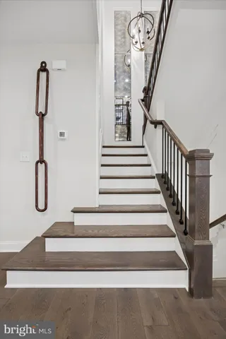 a view of a hallway with wooden floor and entryway