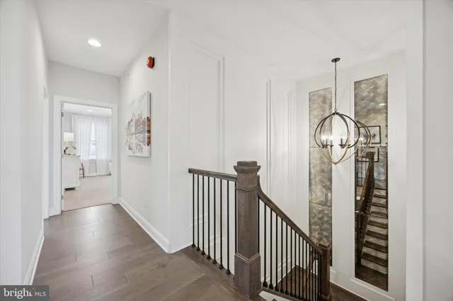 a spacious bedroom with a bed and a flat tv screen