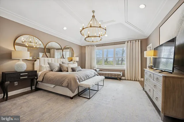 a bedroom with bed tv and window