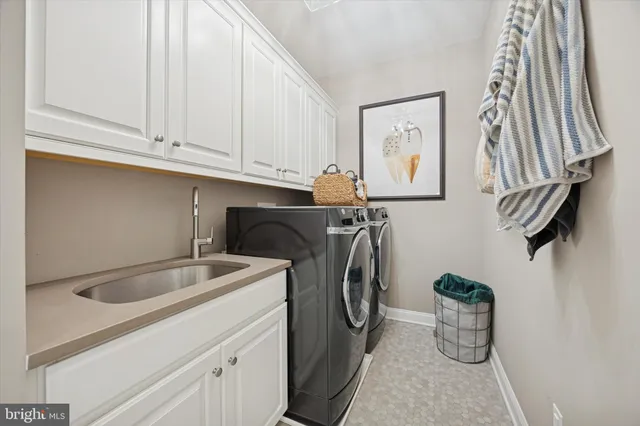 a large kitchen with stainless steel appliances lots of counter space and a sink
